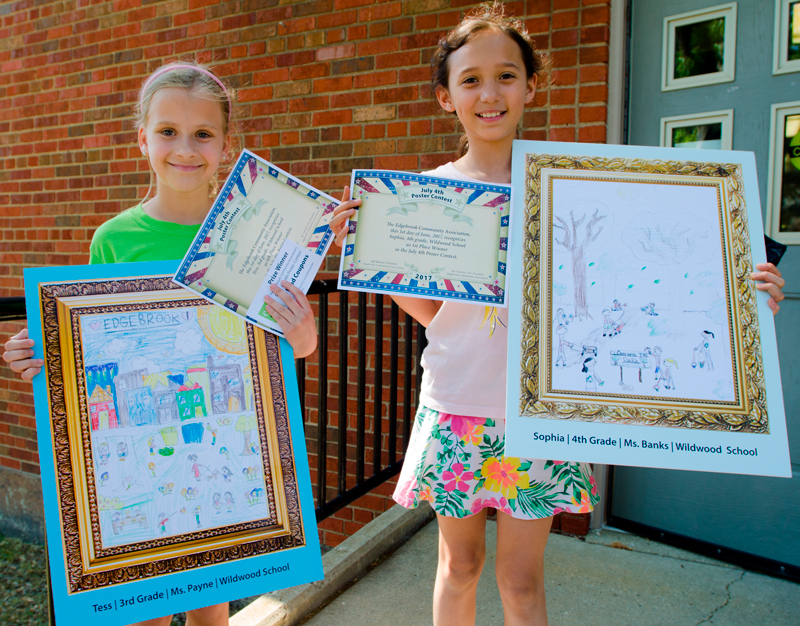 Wildwood artists Tess and Sophia display their winning posters.
