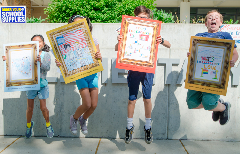 Edgebrook artists jump for joy upon receiving their winning posters.